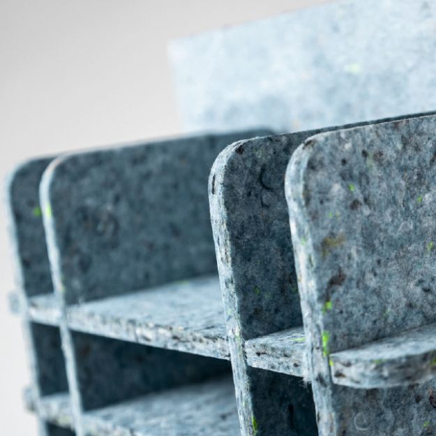 Close-up of a metal bench with a textured surface on a blurred background
